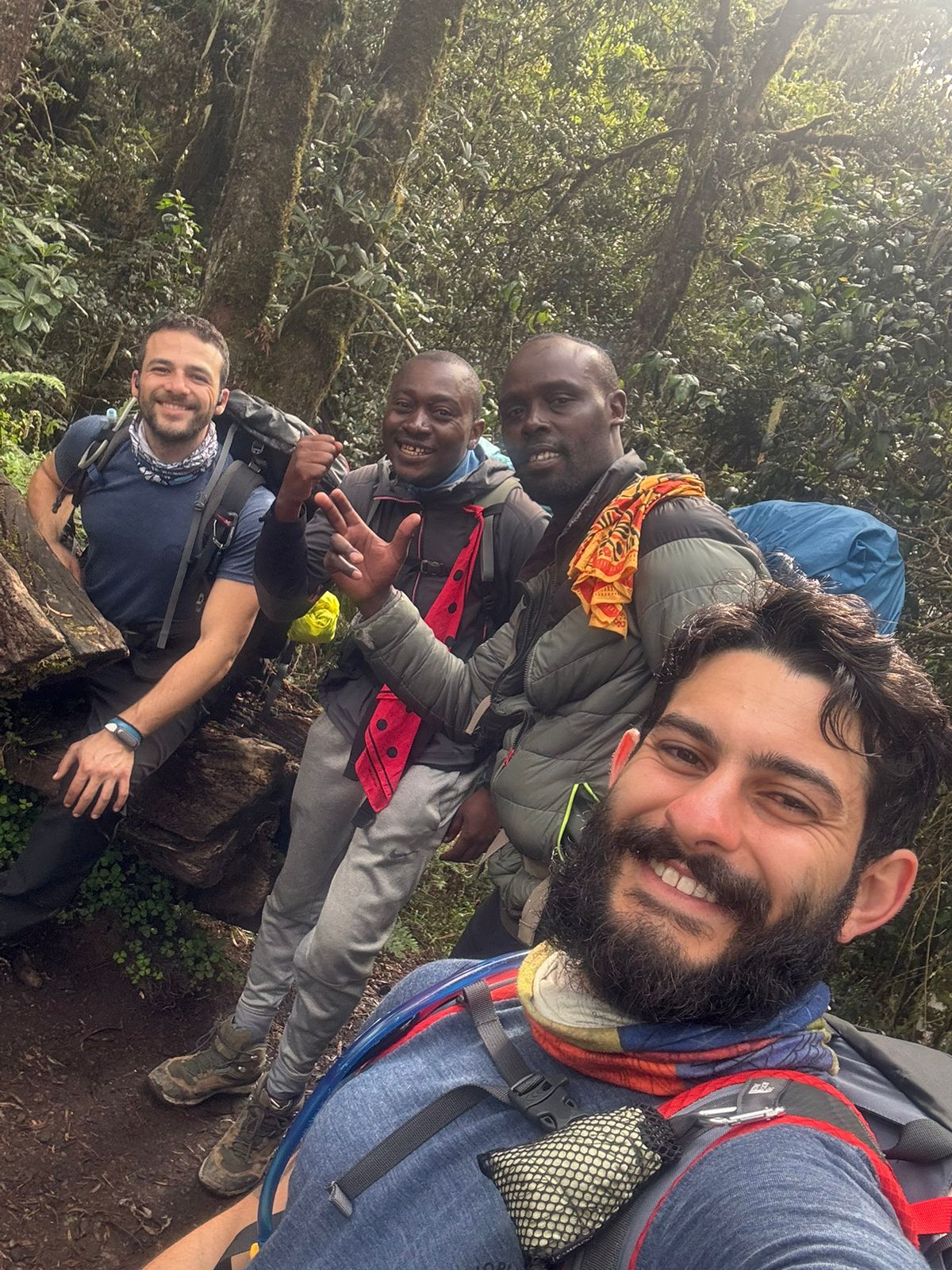 A close group selfie among green forest vegetation